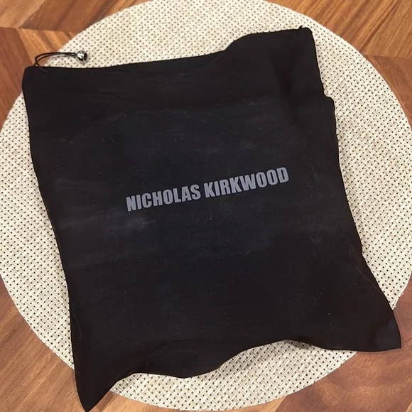 Nicholas Kirkwood black sling-back heals with signature pearl platform.